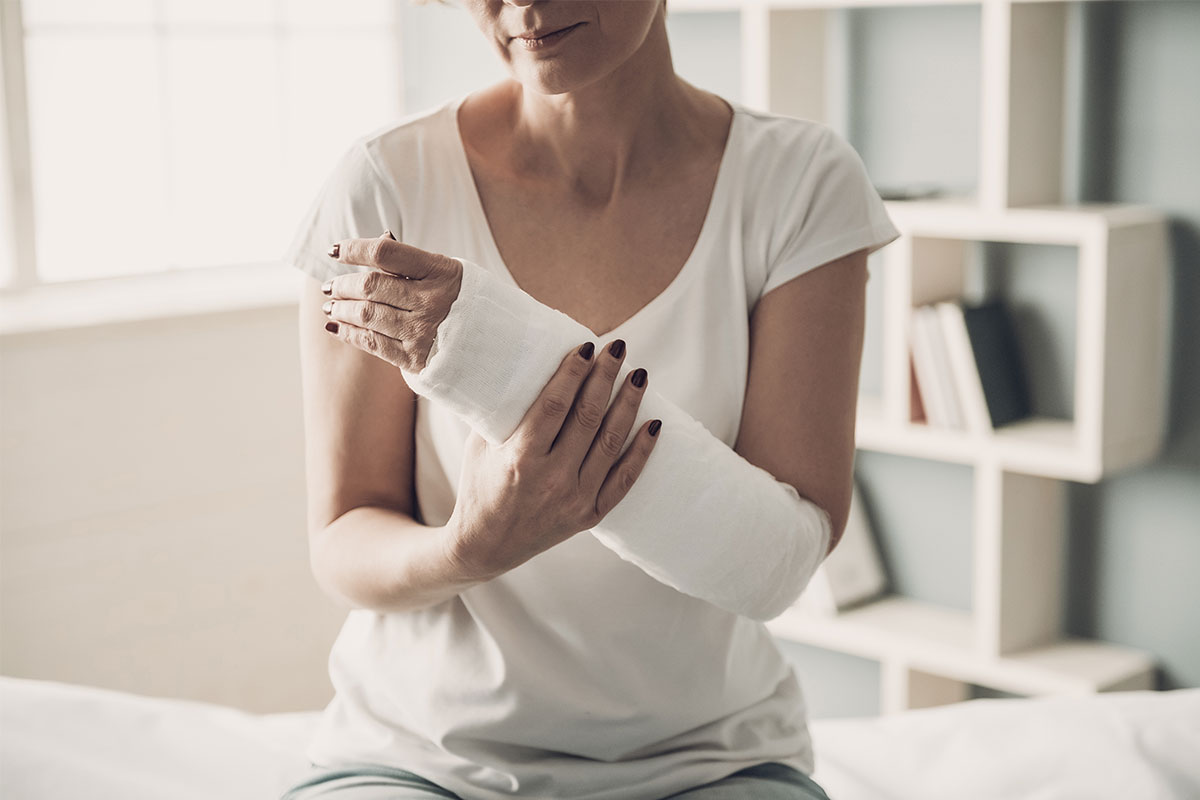 Woman holding hand following surgery.