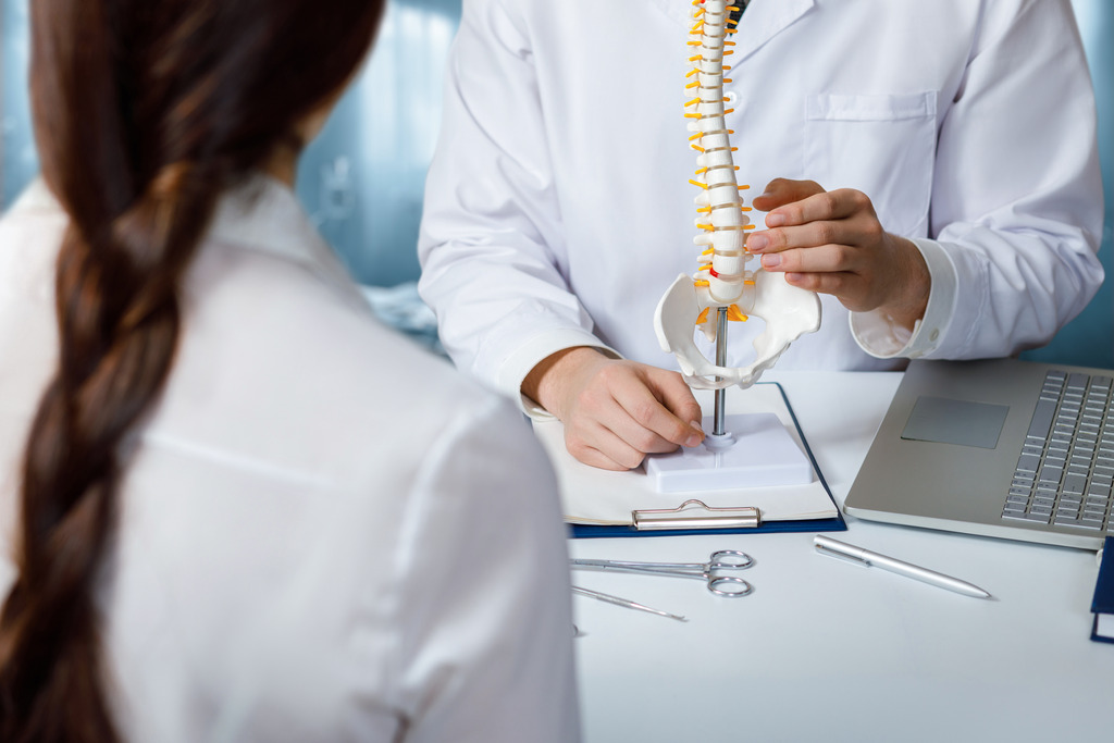 Doctor Talking to Patient About Minimally Invasive Spine Surgery